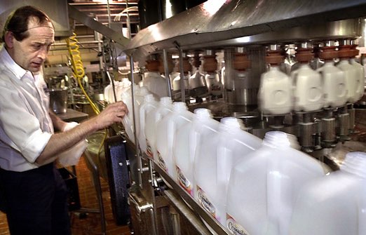 Geno Ballard checks on a plastic gallon bottle filler at the Country Fresh plant in Flint